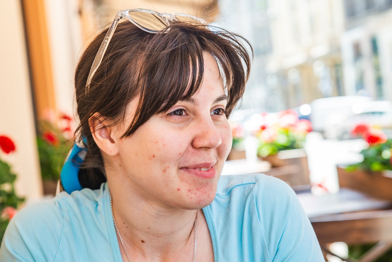 Woman with acne on her cheeks sitting outdoors